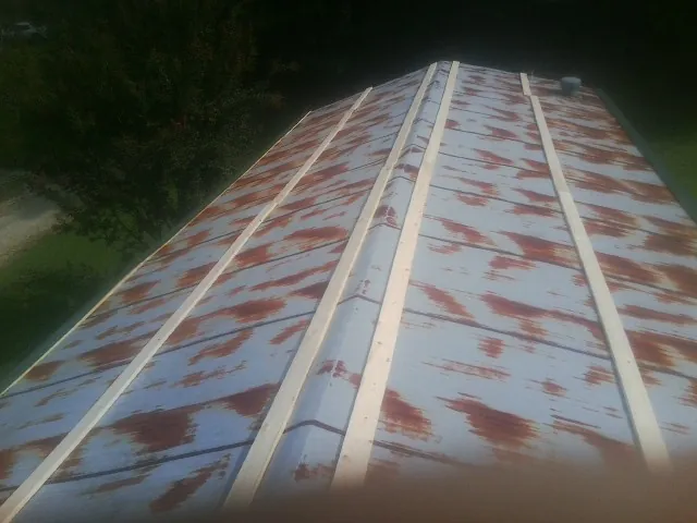 Rusted metal roof panels with new wood purlins before replacement — Storm Damage Roof Repair in Los Angeles by Roofing Brothers