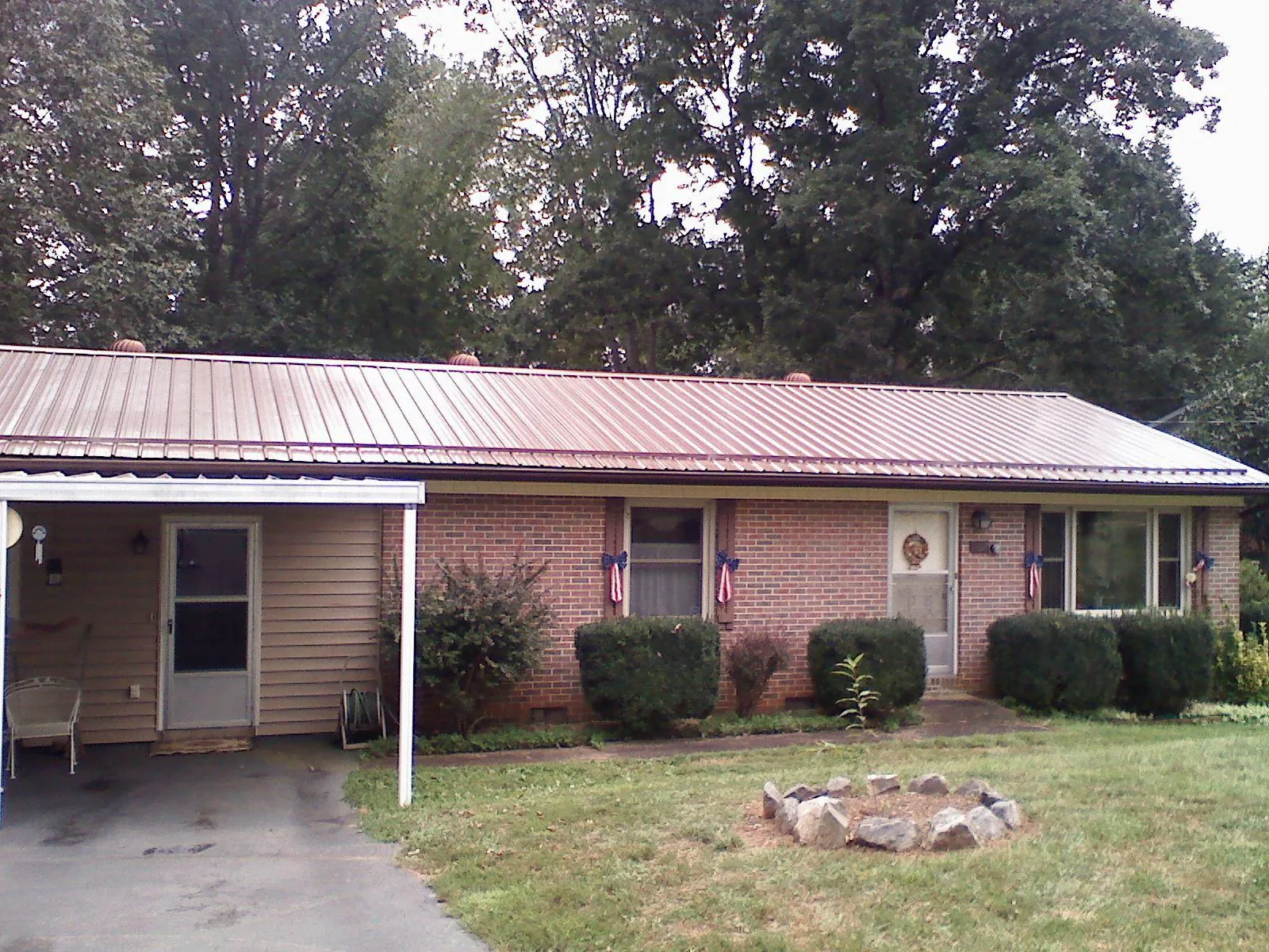 Bronze metal roof and carport on a brick ranch home — Roof Repair work by our crew in Los Angeles