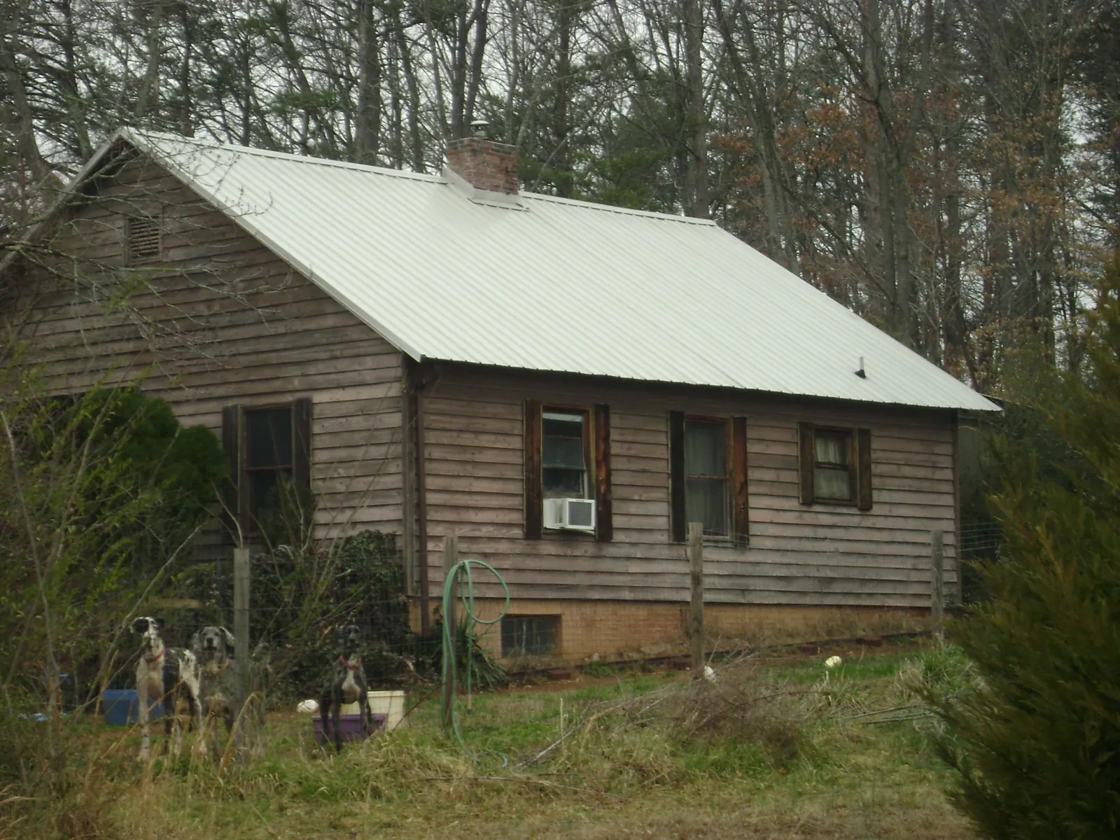 White metal roof on an old wood sided farmhouse, from a Metal Roof Installation job in Los Angeles
